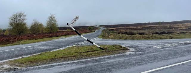 A road with a broken pole
Description automatically generated